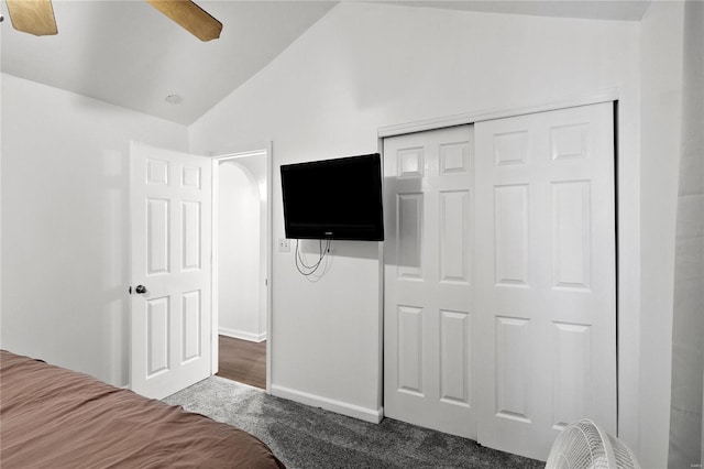 carpeted bedroom with a closet, ceiling fan, and lofted ceiling