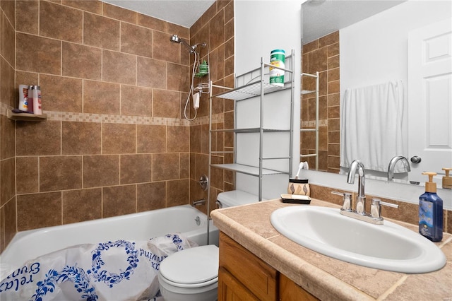 full bathroom featuring vanity, toilet, and tiled shower / bath combo