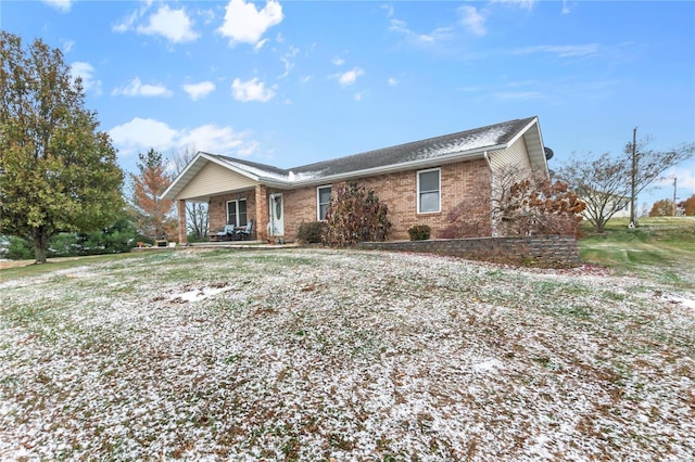 ranch-style house featuring brick siding