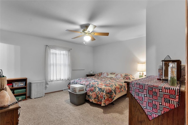 bedroom featuring ceiling fan, baseboards, and carpet