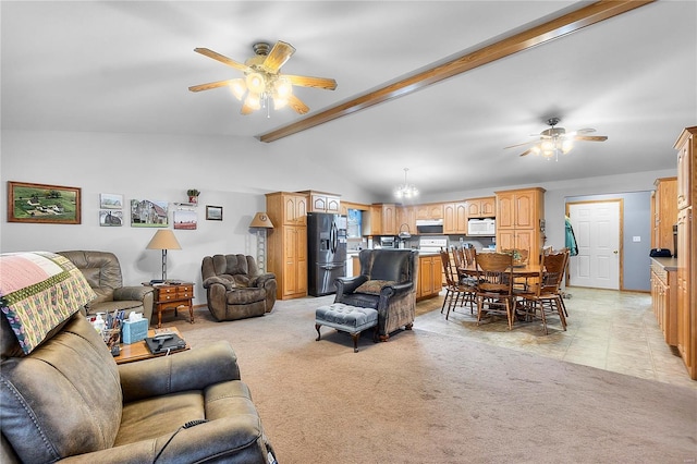 living area with baseboards, light carpet, vaulted ceiling with beams, and ceiling fan with notable chandelier