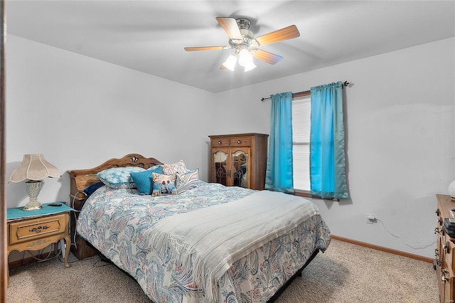 bedroom featuring ceiling fan, carpet, and baseboards
