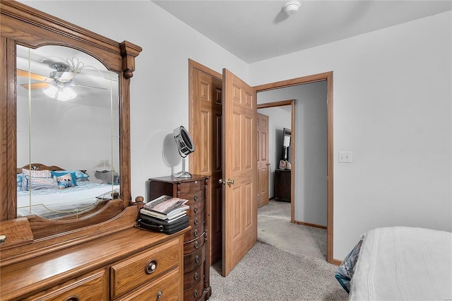 bedroom with baseboards, light colored carpet, and a ceiling fan