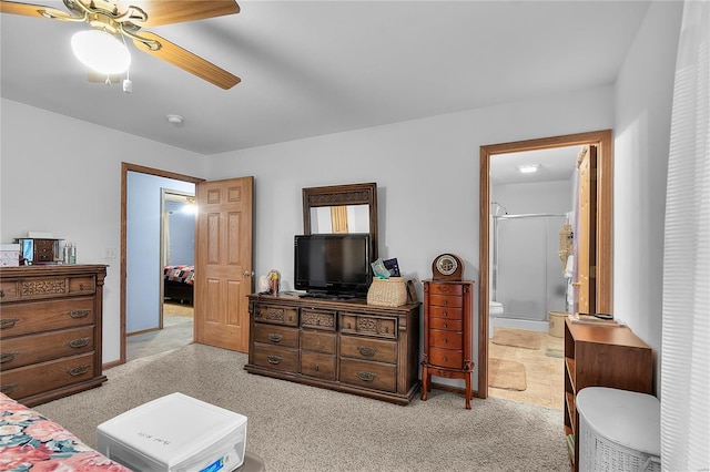 carpeted bedroom with ceiling fan and ensuite bathroom