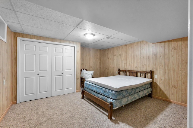 bedroom featuring wooden walls and carpet floors