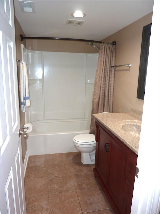 full bathroom with tile patterned floors, shower / bath combo with shower curtain, vanity, and toilet