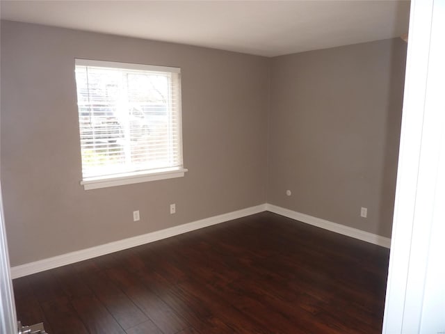 spare room featuring dark hardwood / wood-style floors