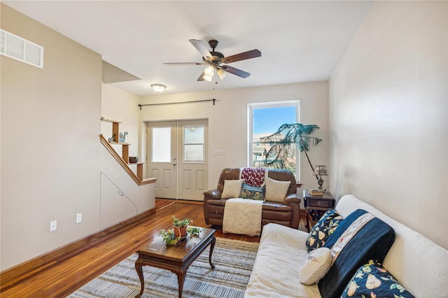 living room with ceiling fan, wood-type flooring, and french doors