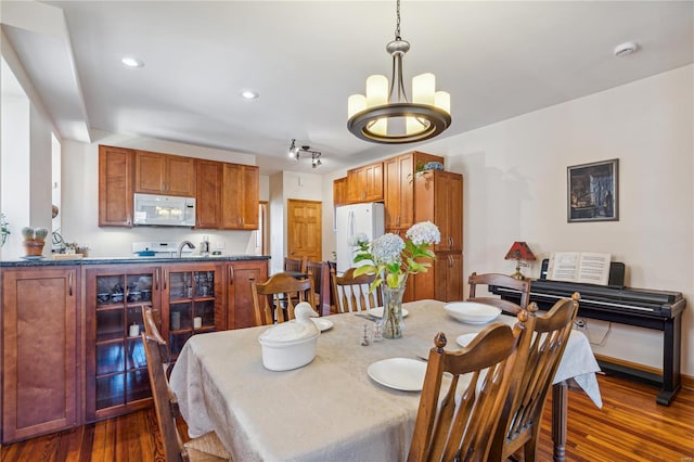 dining room featuring dark hardwood / wood-style floors and a chandelier