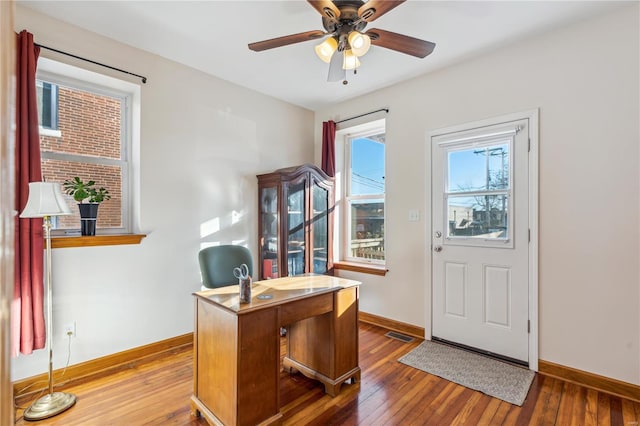 home office with ceiling fan and hardwood / wood-style floors