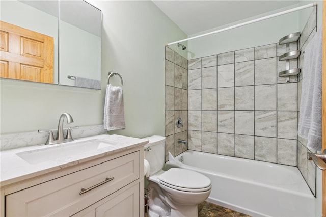full bathroom with tiled shower / bath combo, vanity, and toilet