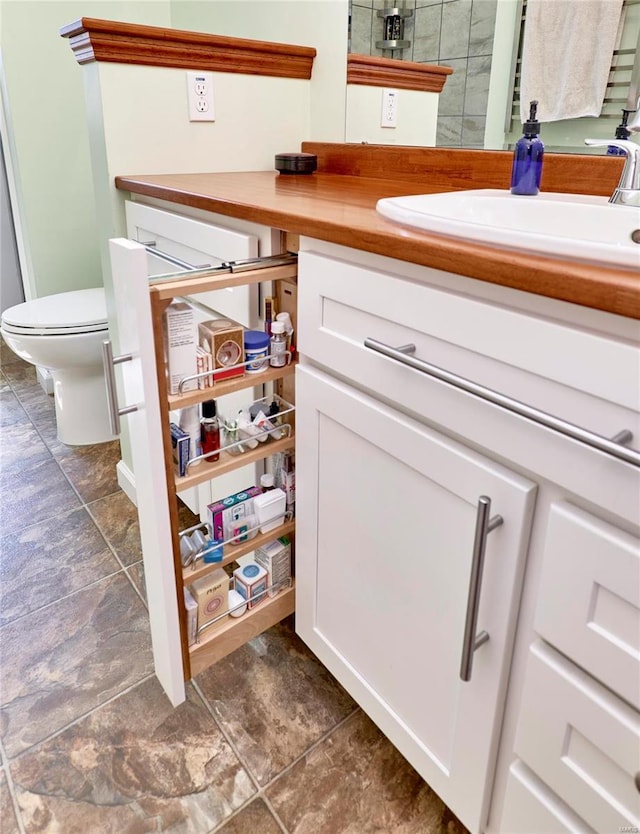 bathroom featuring toilet and vanity