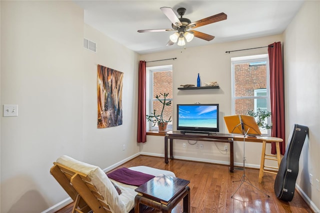 sitting room featuring hardwood / wood-style flooring, ceiling fan, and plenty of natural light