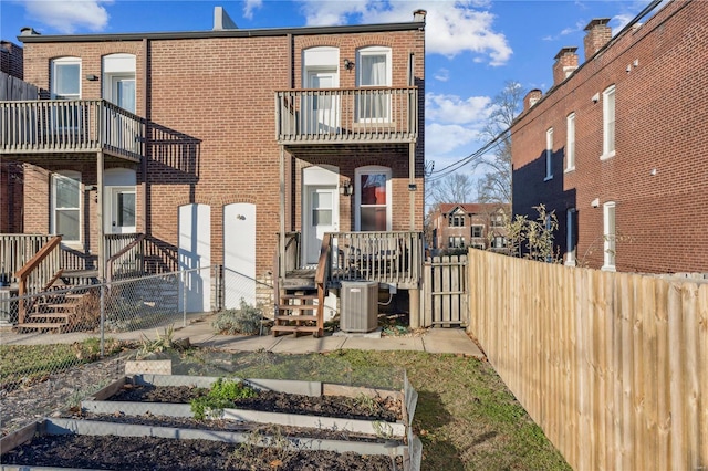 back of house featuring central AC
