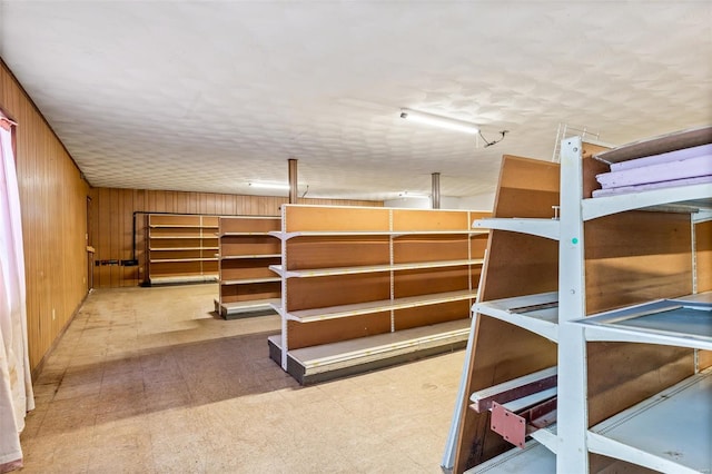 unfurnished bedroom with wooden walls and tile patterned floors