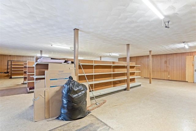 finished below grade area with wood walls and carpet flooring