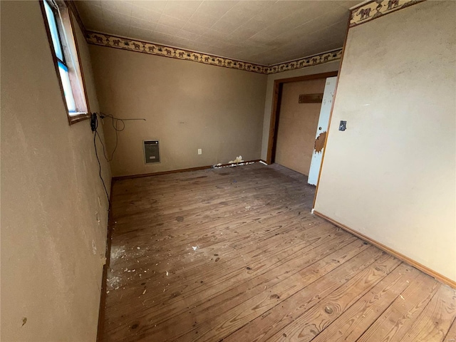 spare room featuring light hardwood / wood-style floors and heating unit