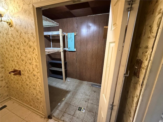 bathroom featuring wooden walls