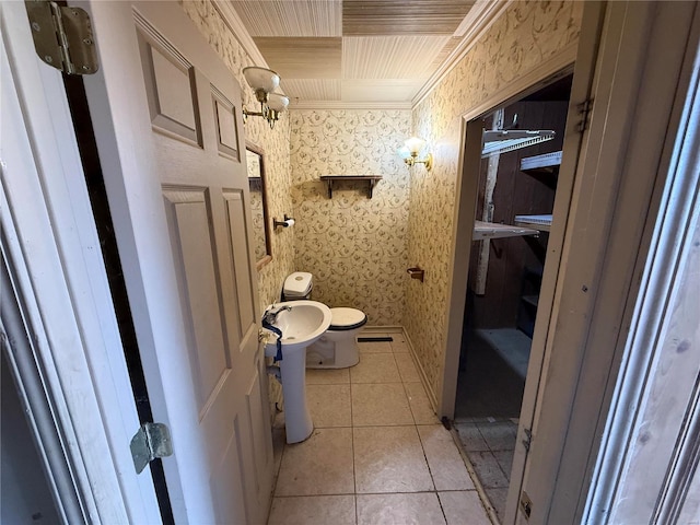 bathroom featuring tile patterned flooring, toilet, and crown molding