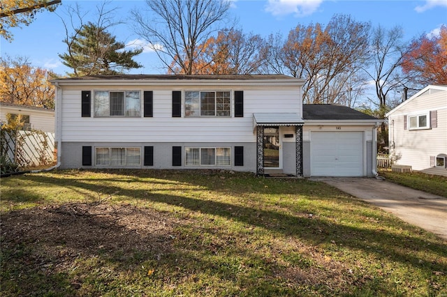 bi-level home with a front lawn and a garage