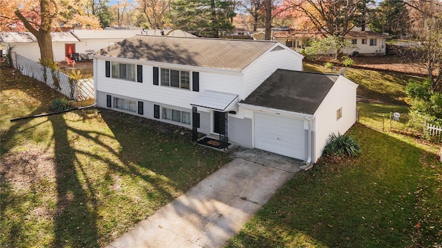 view of front of property featuring a garage and a front lawn