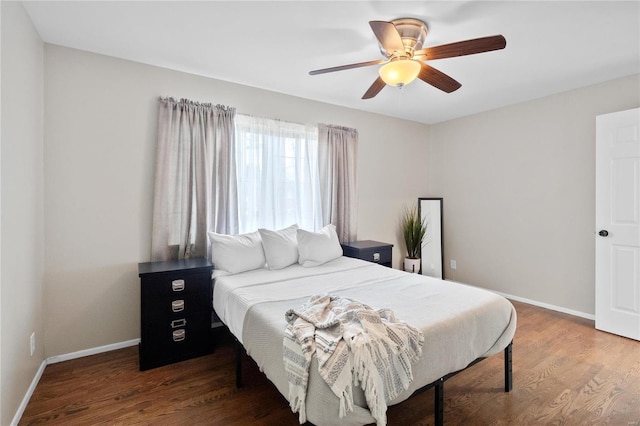 bedroom with ceiling fan and dark wood-type flooring