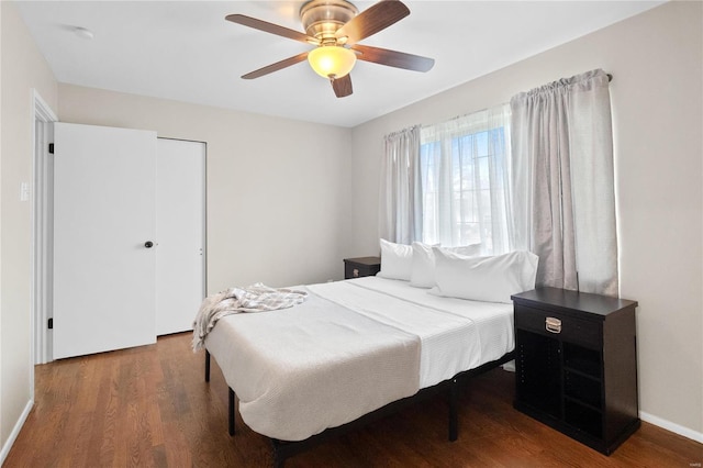 bedroom with hardwood / wood-style flooring, ceiling fan, and a closet