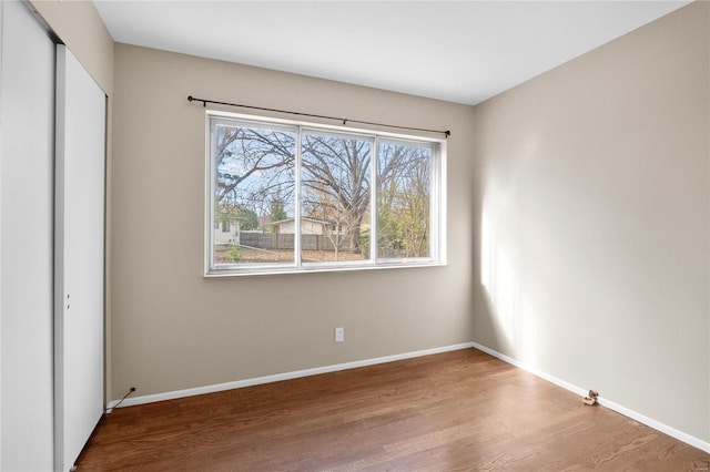 unfurnished bedroom featuring hardwood / wood-style flooring and a closet