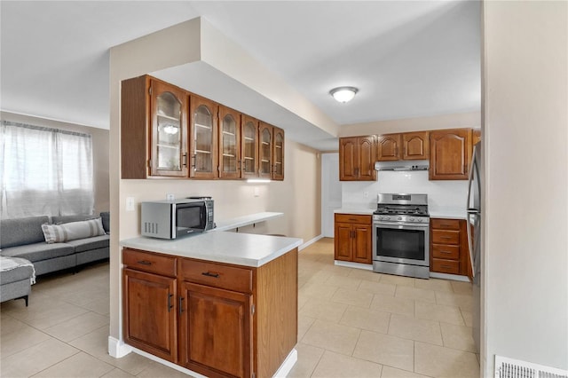 kitchen with light tile patterned floors and stainless steel appliances