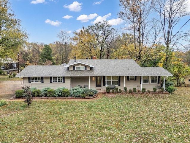 single story home with covered porch and a front yard