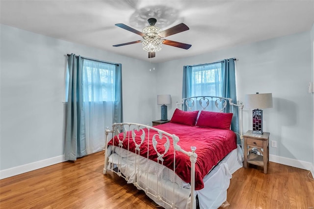 bedroom with wood-type flooring and ceiling fan