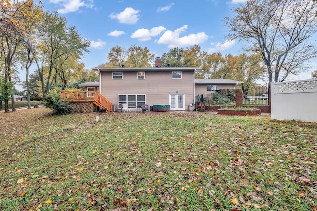 back of property featuring a yard and a wooden deck