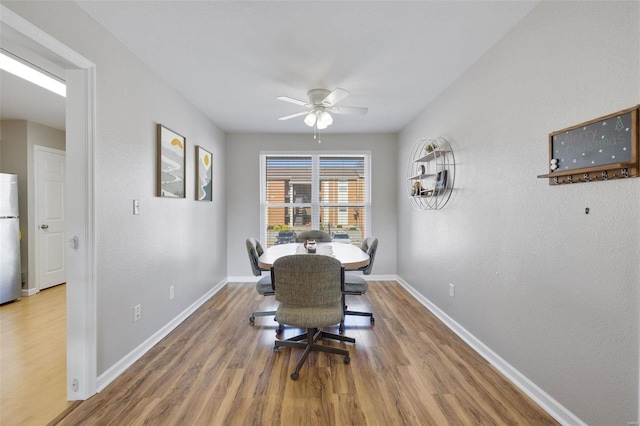 dining room with hardwood / wood-style flooring and ceiling fan