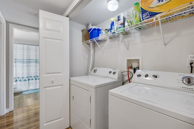 washroom featuring separate washer and dryer and hardwood / wood-style flooring