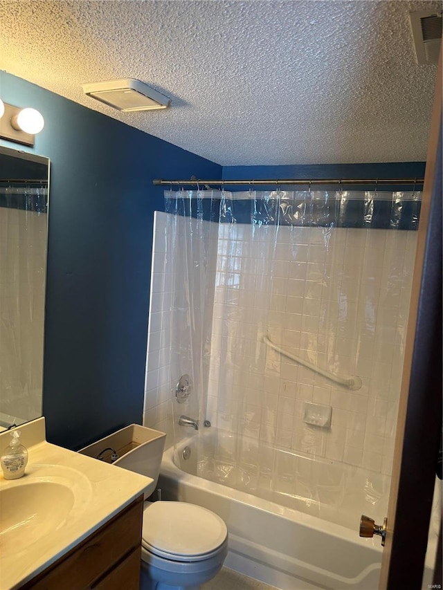 full bathroom featuring shower / tub combo with curtain, vanity, toilet, and a textured ceiling