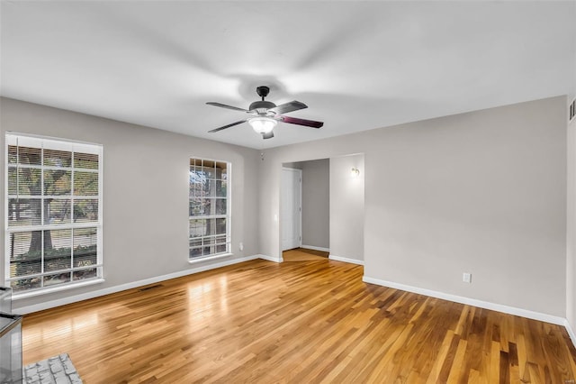 unfurnished room with ceiling fan and light wood-type flooring