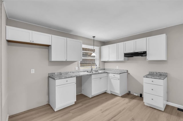 kitchen featuring light hardwood / wood-style flooring, white cabinets, and sink