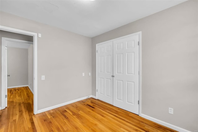 unfurnished bedroom featuring a closet and wood-type flooring