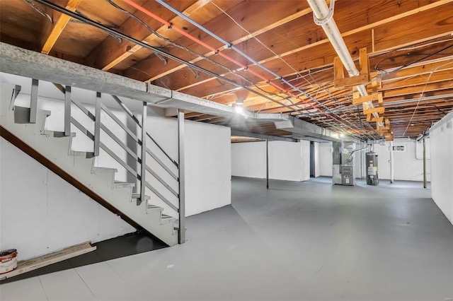 basement featuring gas water heater and heating unit