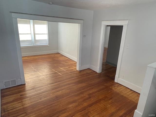 unfurnished room with dark hardwood / wood-style floors