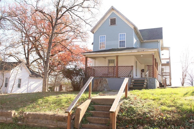 view of front of home featuring covered porch and a front yard