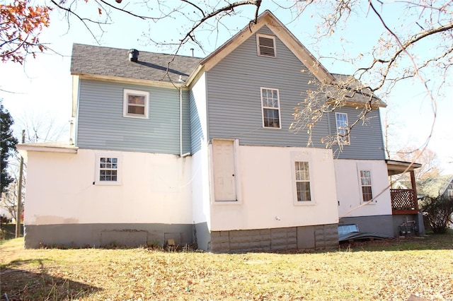 back of property with a lawn