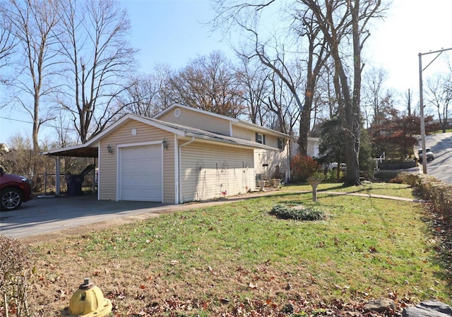 view of side of property featuring a yard, a garage, and a carport