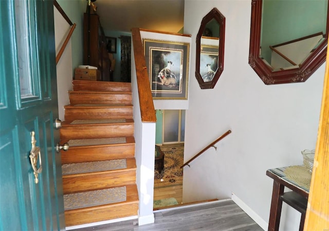 stairs featuring hardwood / wood-style flooring