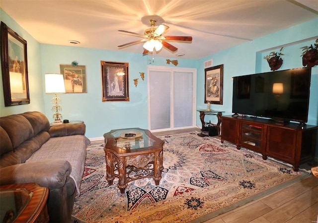 living room with hardwood / wood-style flooring and ceiling fan