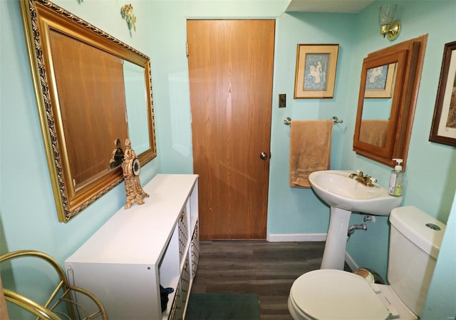 bathroom featuring hardwood / wood-style floors and toilet