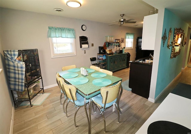 dining space featuring ceiling fan and light hardwood / wood-style flooring