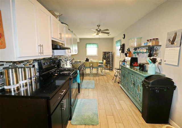 kitchen featuring light hardwood / wood-style flooring, ceiling fan, decorative backsplash, black range with electric cooktop, and white cabinetry