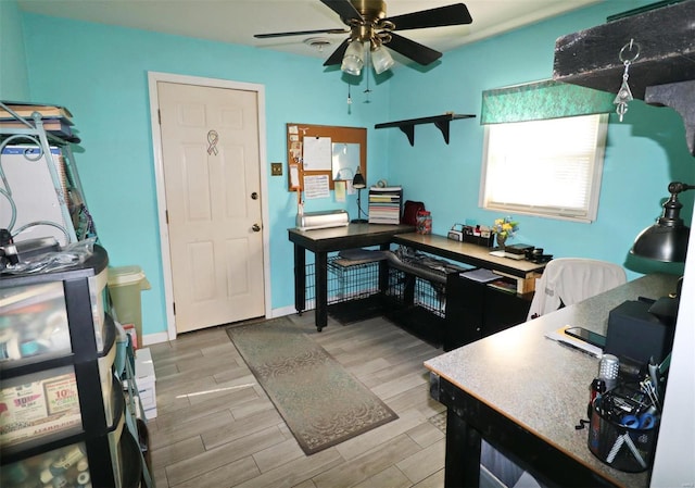 office space with ceiling fan and light hardwood / wood-style flooring