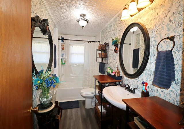 full bathroom with sink, shower / bath combo, crown molding, wood-type flooring, and toilet